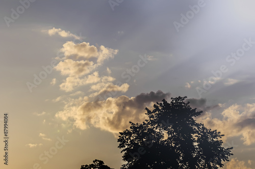 Clouds in blue sky and rays of sun