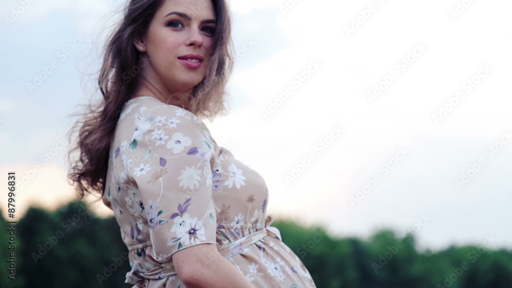 Caucasian pregnant woman in a wheat field. Caucasian pregnant woman in a wheat field.