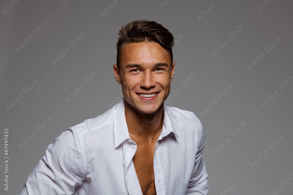 Smiling Young Man In Unbuttoned White Shirt Smiling Young Man In Unbuttoned White Shirt