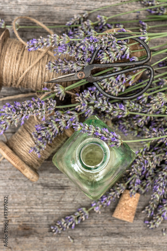 Perfumed herbal oil essence and lavender flowers. Vintage decora