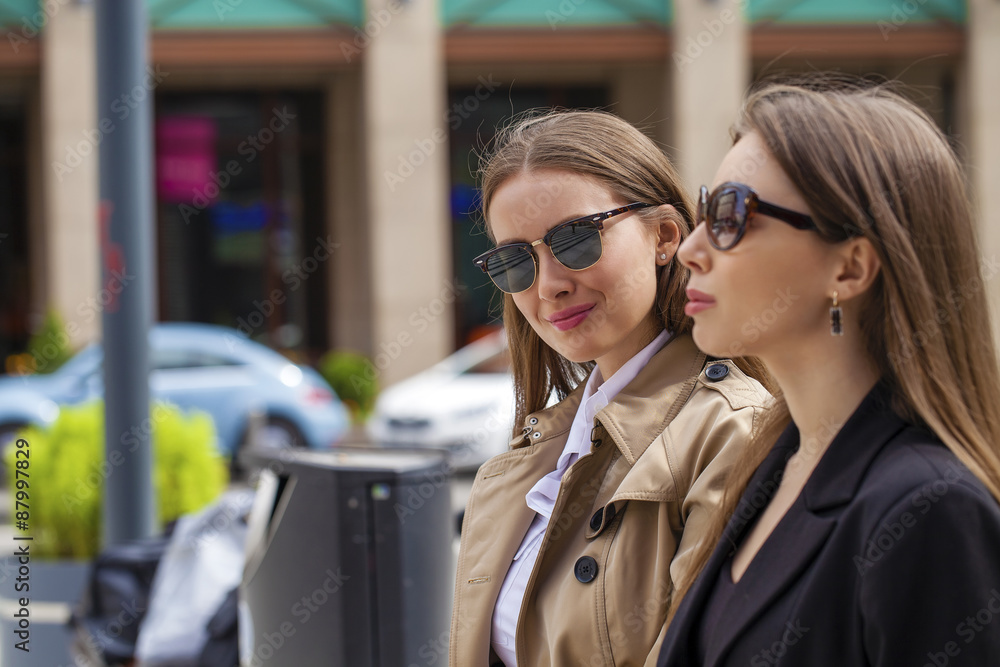Two young beautiful business women шт sunglasses