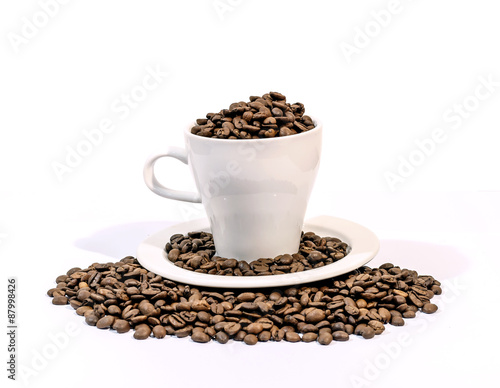 Coffee beans in a white coffee cup on a white background