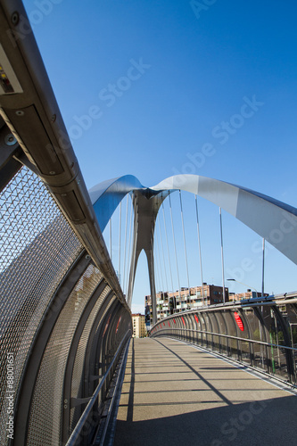 modern footbridge with supporting arches and steel bulkheads