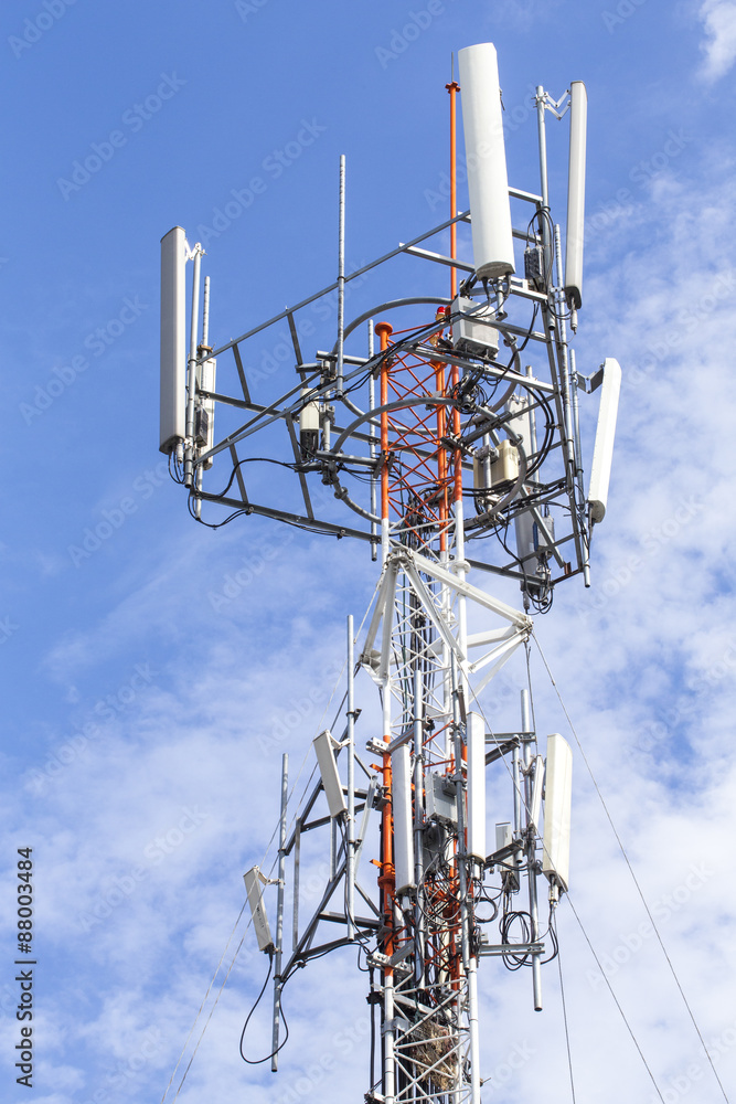 Cell Phone Tower with White Cloud and Blue Sky