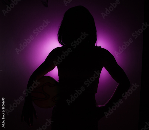   Silhouette of a girl with ball.  