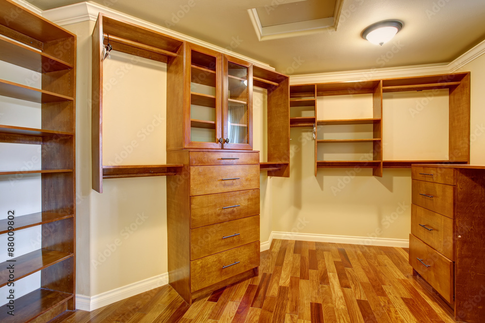 Large walk in closet with many shelves and drawers. Large walk in closet with many shelves and drawers.