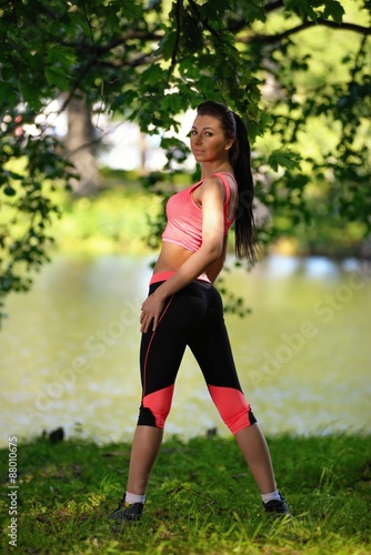 Portrait of fashion fitness model posing in park © dojo666