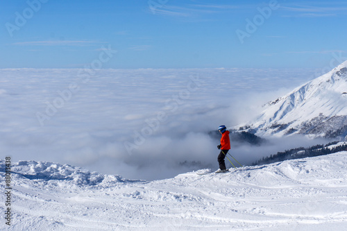 skier on top of mountain above the clouds © Vasily Merkushev