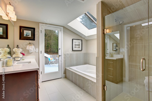 Luxury master bathroom with white tile floor.