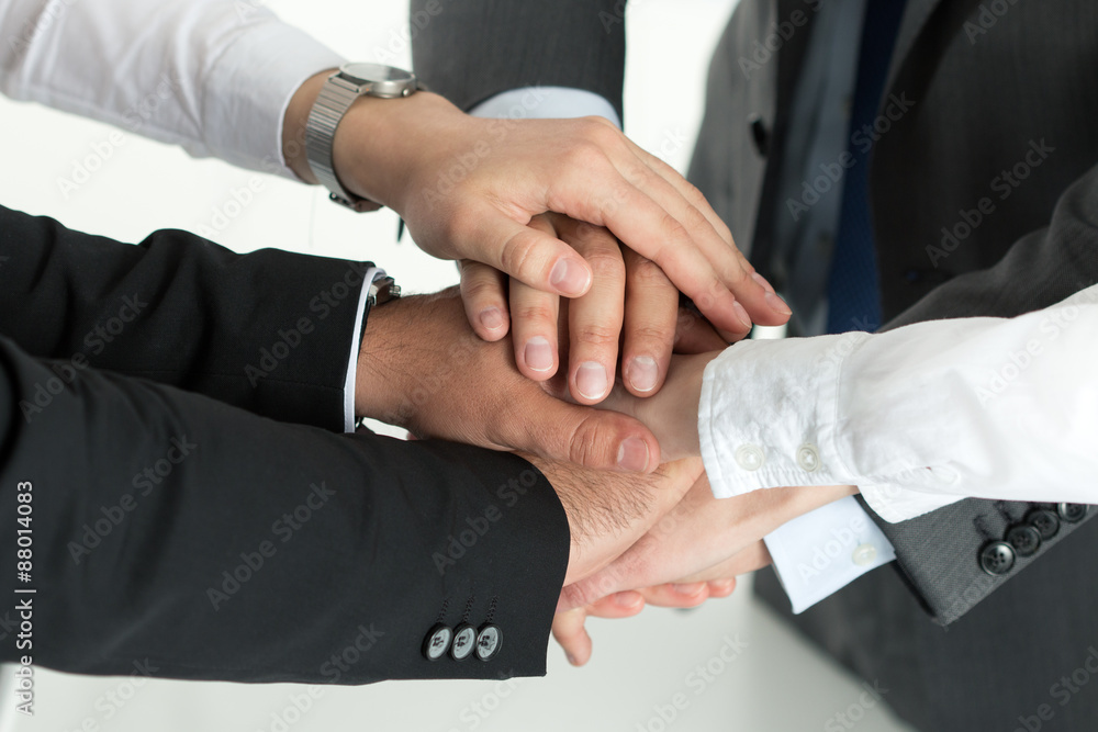 Closeup of business team showing unity with putting their hands