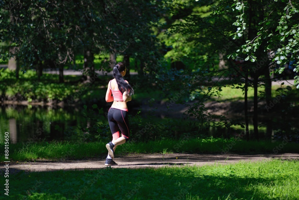 Beautiful woman runner running in city park Beautiful woman runner running in city park
