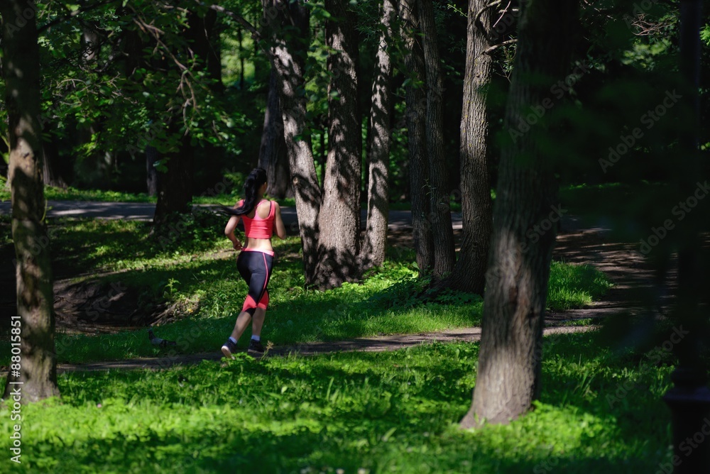 Beautiful woman runner running in city park Beautiful woman runner running in city park