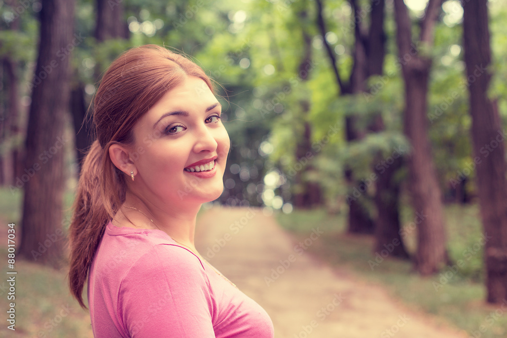 Closeup portrait young smiling woman outdoors in park on summer Closeup portrait young smiling woman outdoors in park on summer