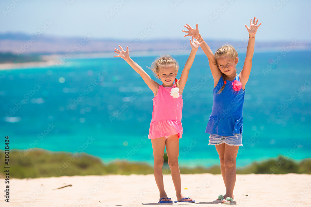 Adorable little girls having fun during beach vacation Adorable little girls having fun during beach vacation