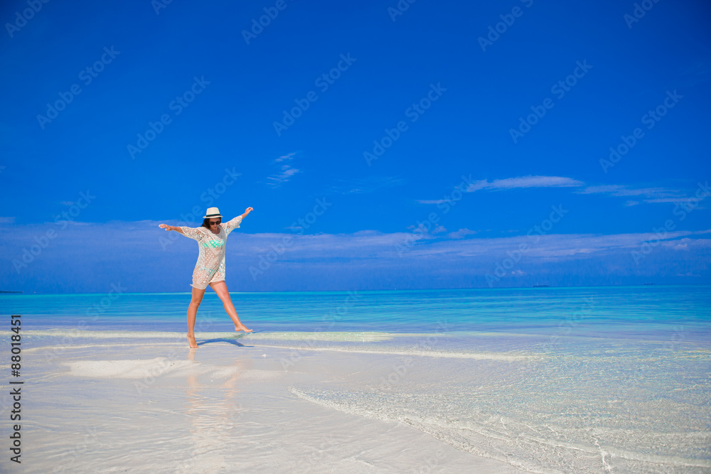 Young beautiful woman on beach during tropical vacation Young beautiful woman on beach during tropical vacation