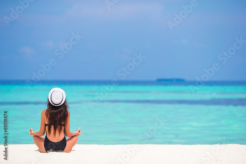 Beautiful girl in yoga position during tropical vacation © travnikovstudio