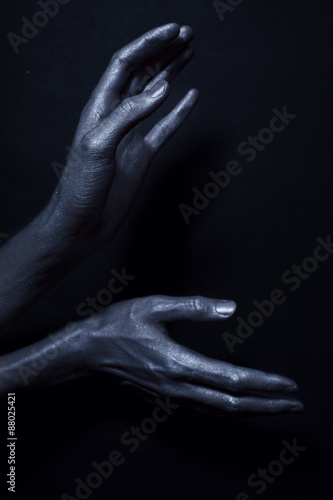 beautiful man s hands in silver paint