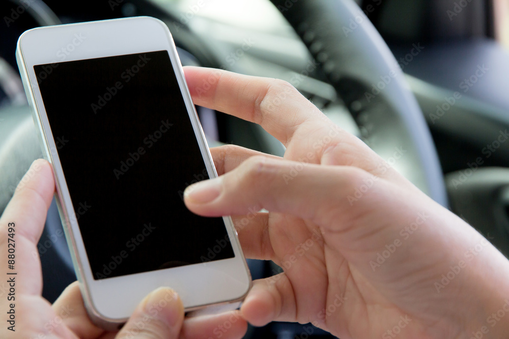 Young woman holding mobile device in the car Young woman holding mobile device in the car