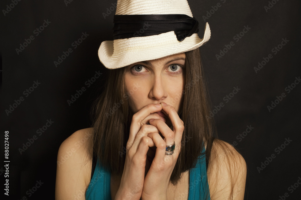 Studio shoulder portrait of young blue-eyed girl in white hat Studio shoulder portrait of young blue-eyed girl in white hat