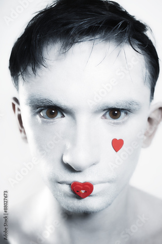 young brunette man with white skin and red heart on lips
