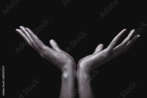 beautiful man's hands in silver paint