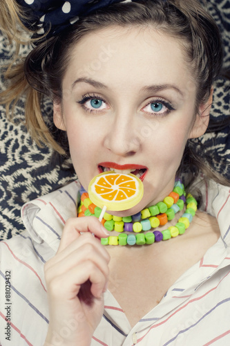 young woman biting  sugar candy