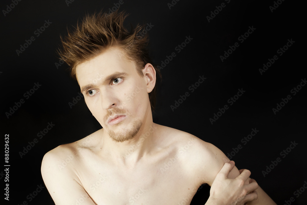 young serious man with blue eyes and a stylish hairstyle young serious man with blue eyes and a stylish hairstyle