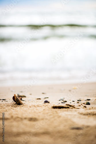 Sandy Beach, Pebbles and Sea on the Background