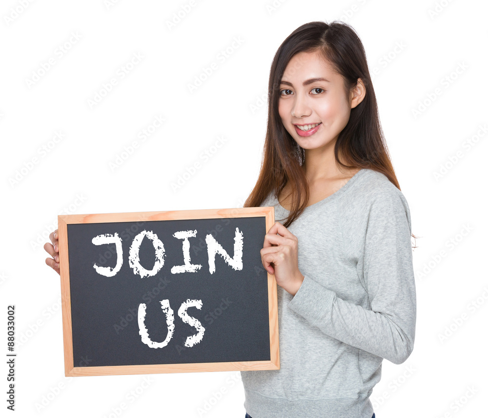 Pretty woman hold with blackboard and showing phrase of join us Pretty woman hold with blackboard and showing phrase of join us