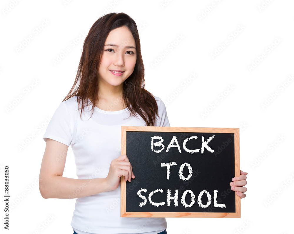 Young woman hold with blackboard showing phrase of back to schoo Young woman hold with blackboard showing phrase of back to schoo