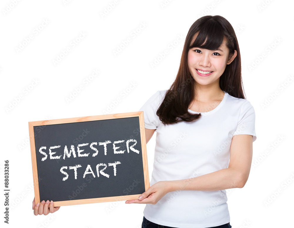 Woman hold with chalkboard showing semester start Woman hold with chalkboard showing semester start