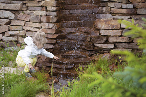 The child in front of a small waterfall