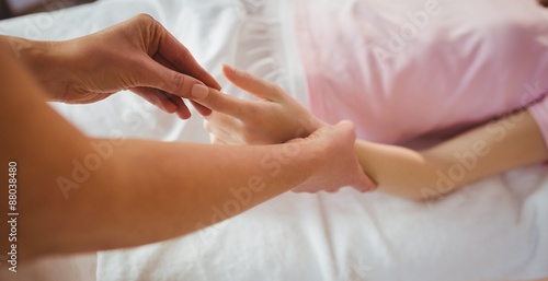 Young woman getting hand massage