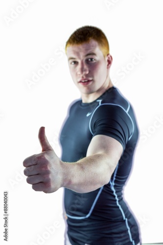 Muscular rugby player gesturing thumbs up