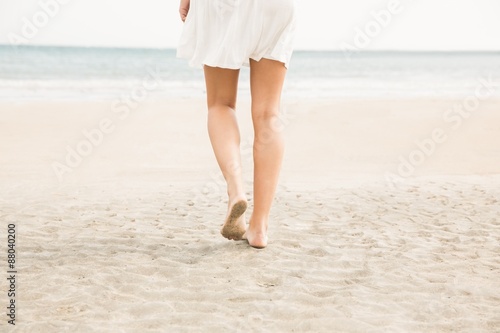 Stylish woman walking on the sand © WavebreakMediaMicro