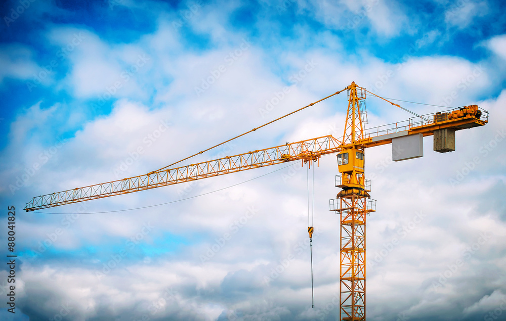 Working crane in the sky. Construction site.