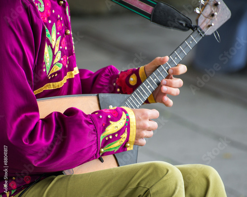 Man playing balalaika on the street. Unrecognizable person. photo
