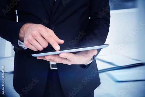 Composite image of mid section of a businessman 