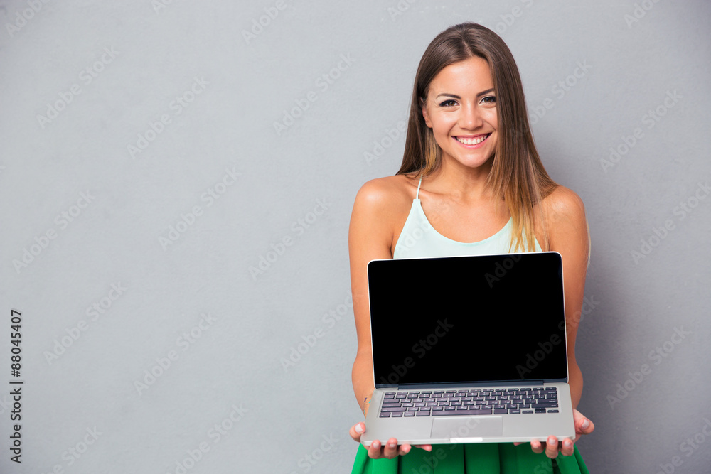 Woman showing blank laptop computer screen Woman showing blank laptop computer screen