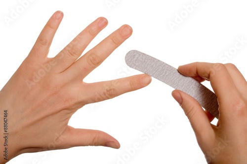 Young woman filing nails, close-up