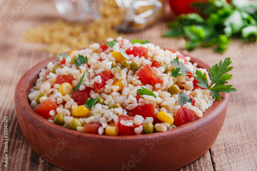 cooked bulgur with tomato corn and green peas