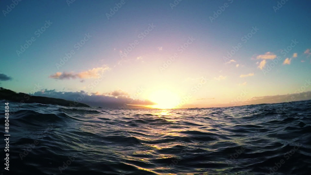 Floating in the Ocean Watching the Sunset in Slow Motion. Ocean Waves Rising and Falling. Floating in the Ocean Watching the Sunset in Slow Motion. Ocean Waves Rising and Falling.