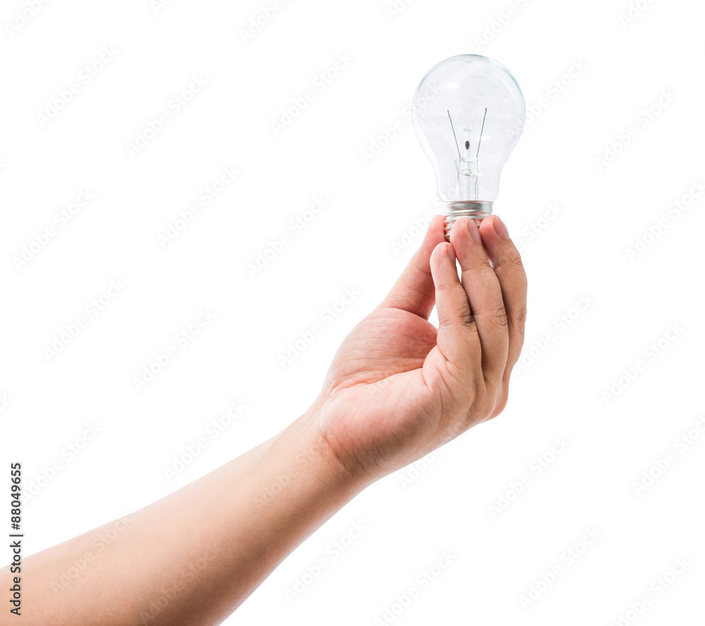 Hand holding an incandescent light bulb isolated on white backgr Hand holding an incandescent light bulb isolated on white backgr