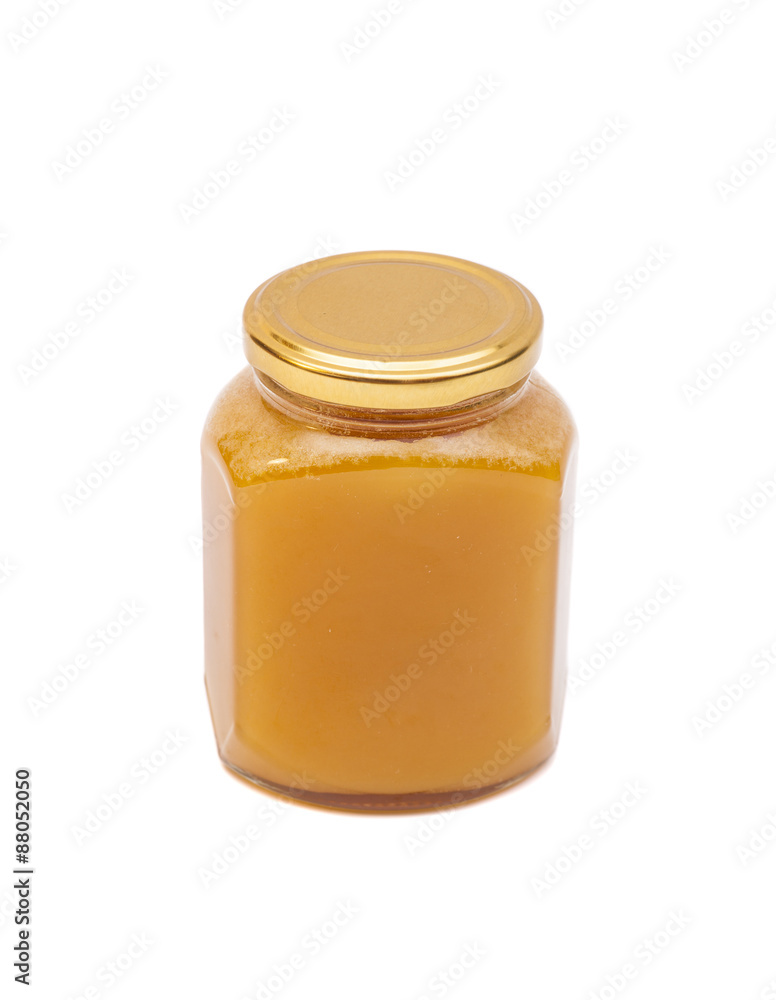 Honey in jar on white background Honey in jar on white background