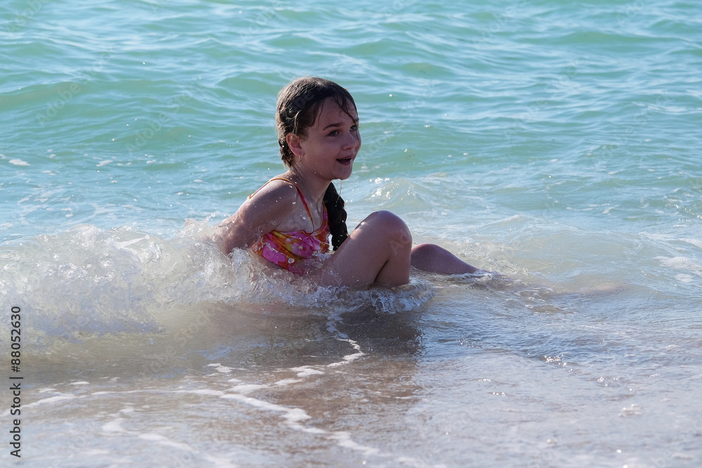 Children play in a sea surf Children play in a sea surf