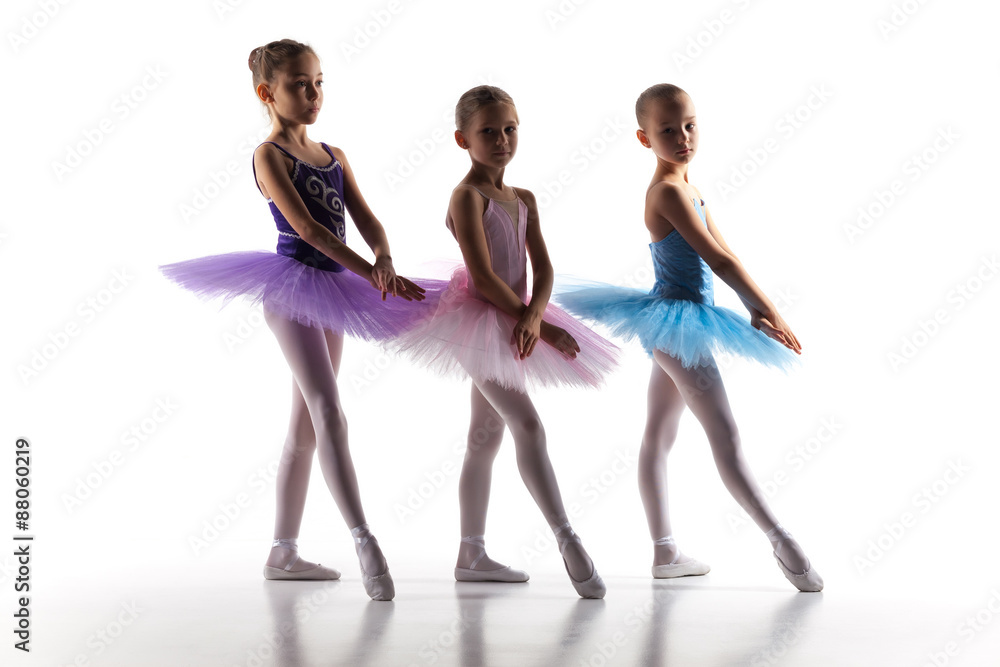 Fototapeta premium Three little ballerinas dancing in dance studio