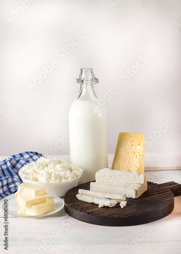 Dairy products on white wooden table.