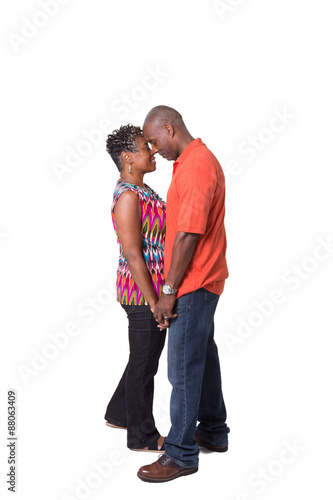 Full length portrait of an older couple standing close 