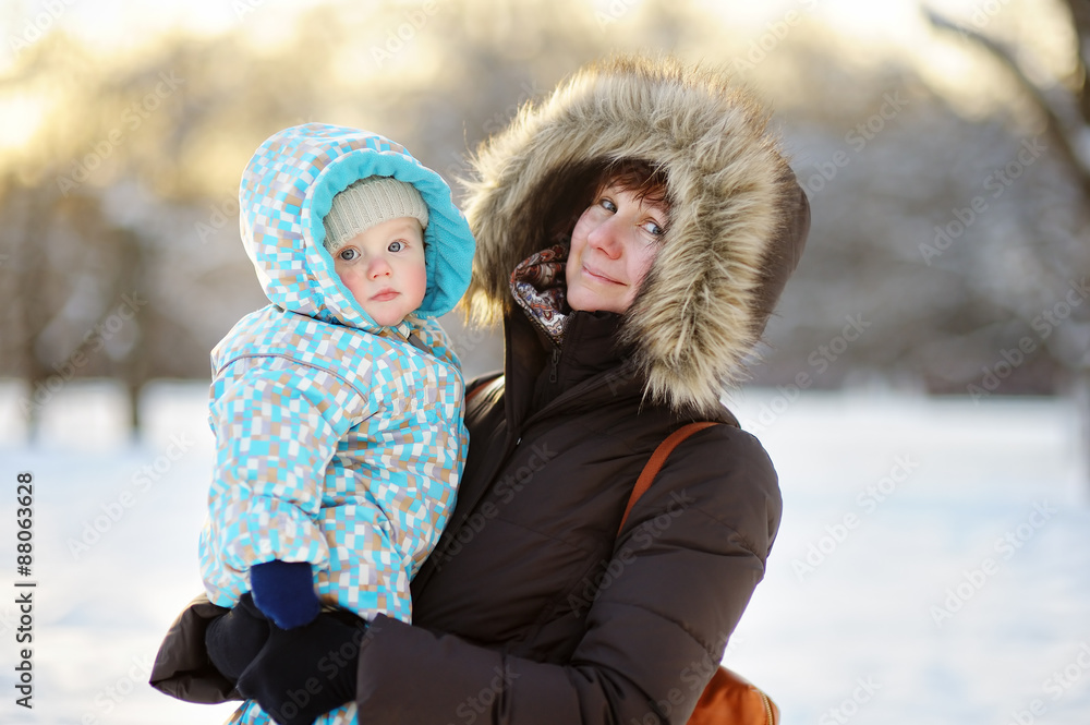 Beautiful woman and her little grandson at the winter