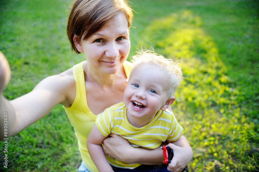 Woman and her adorable toddler grandson making selfie Woman and her adorable toddler grandson making selfie
